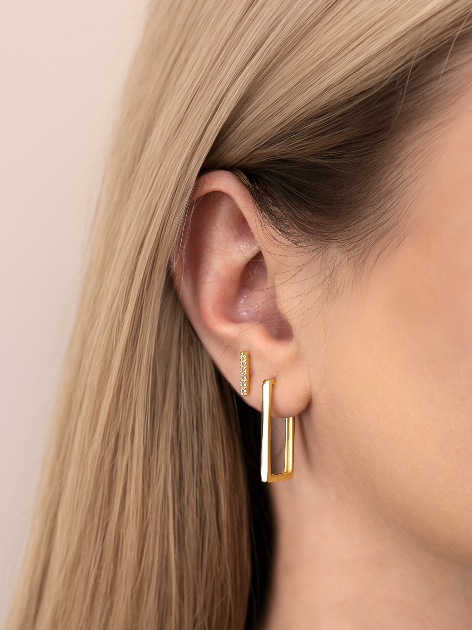 Model wearing FAVES rectangular hoop earrings – side ear view
