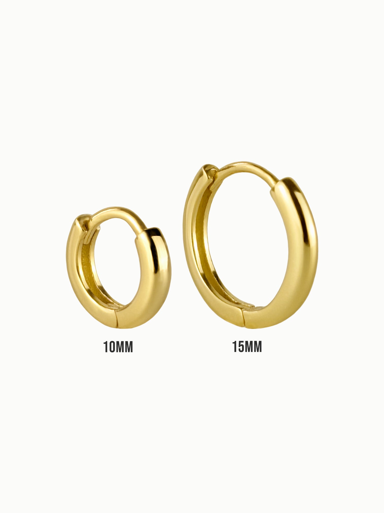Close-up of FAVES Hailey huggie hoop earrings in 10mm and 15mm, crafted in sterling silver with thick 18K gold plating, hypoallergenic finish.