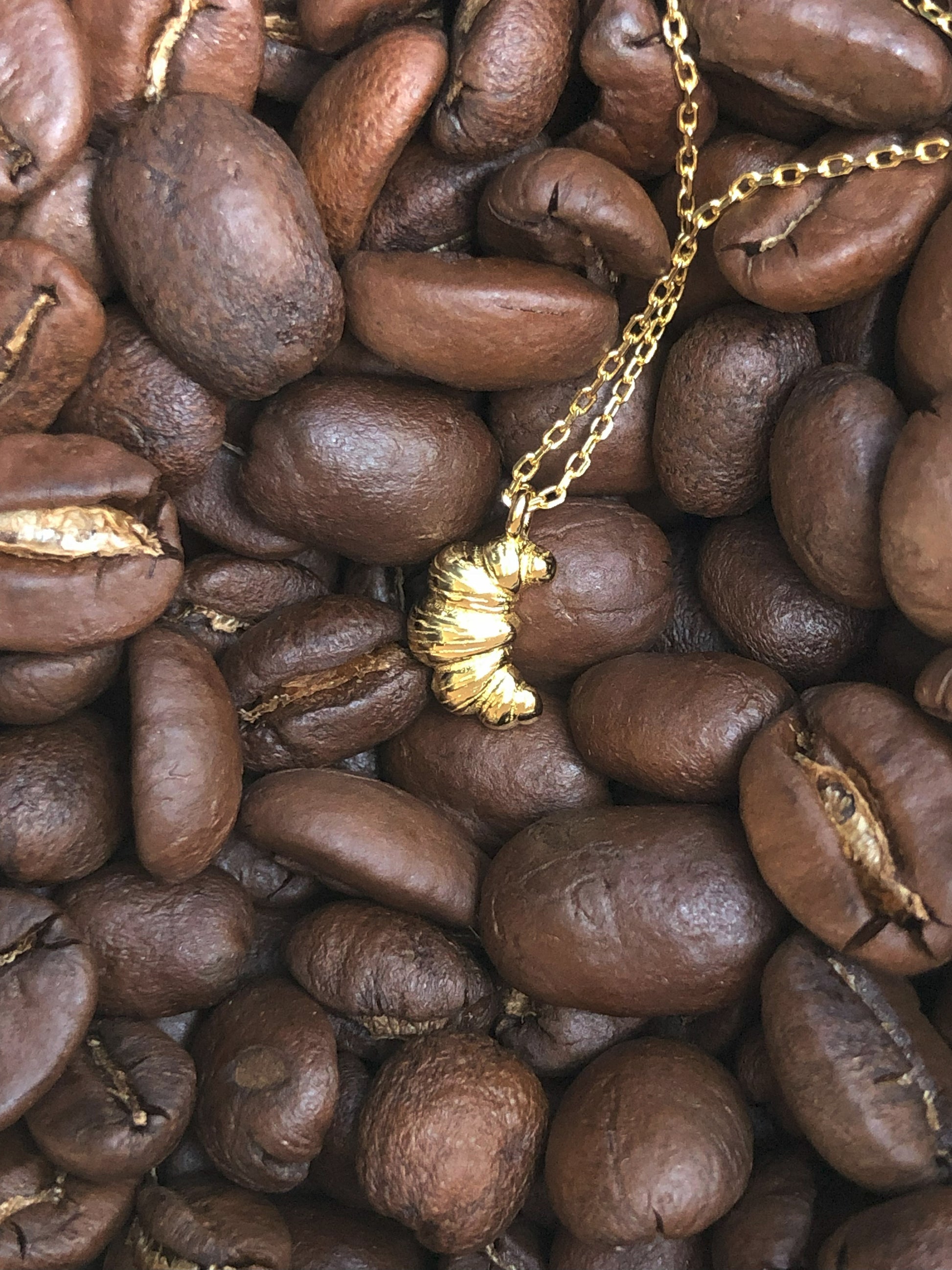 FAVES Croissant Necklace on coffee beans – 18K gold plated sterling silver croissant pendant, textured minimal charm, hypoallergenic and waterproof