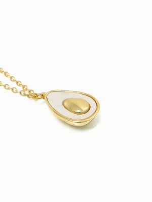 FAVES Avocado Necklace close-up – teardrop-shaped pendant with white enamel and smooth gold pit, 18K gold plated brass, hypoallergenic, tarnish-resistant