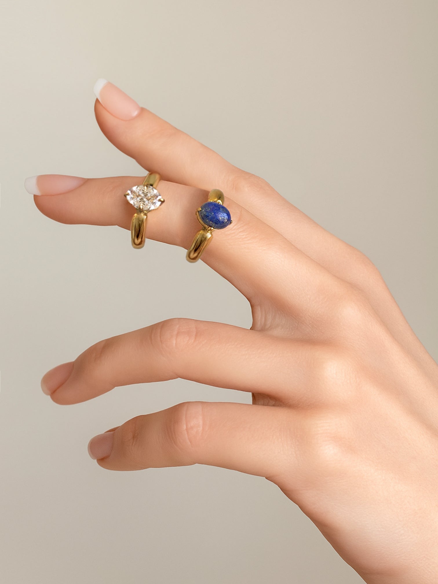 Model wearing FAVES Katella Rings – oval white CZ and lapis solitaire gold bands