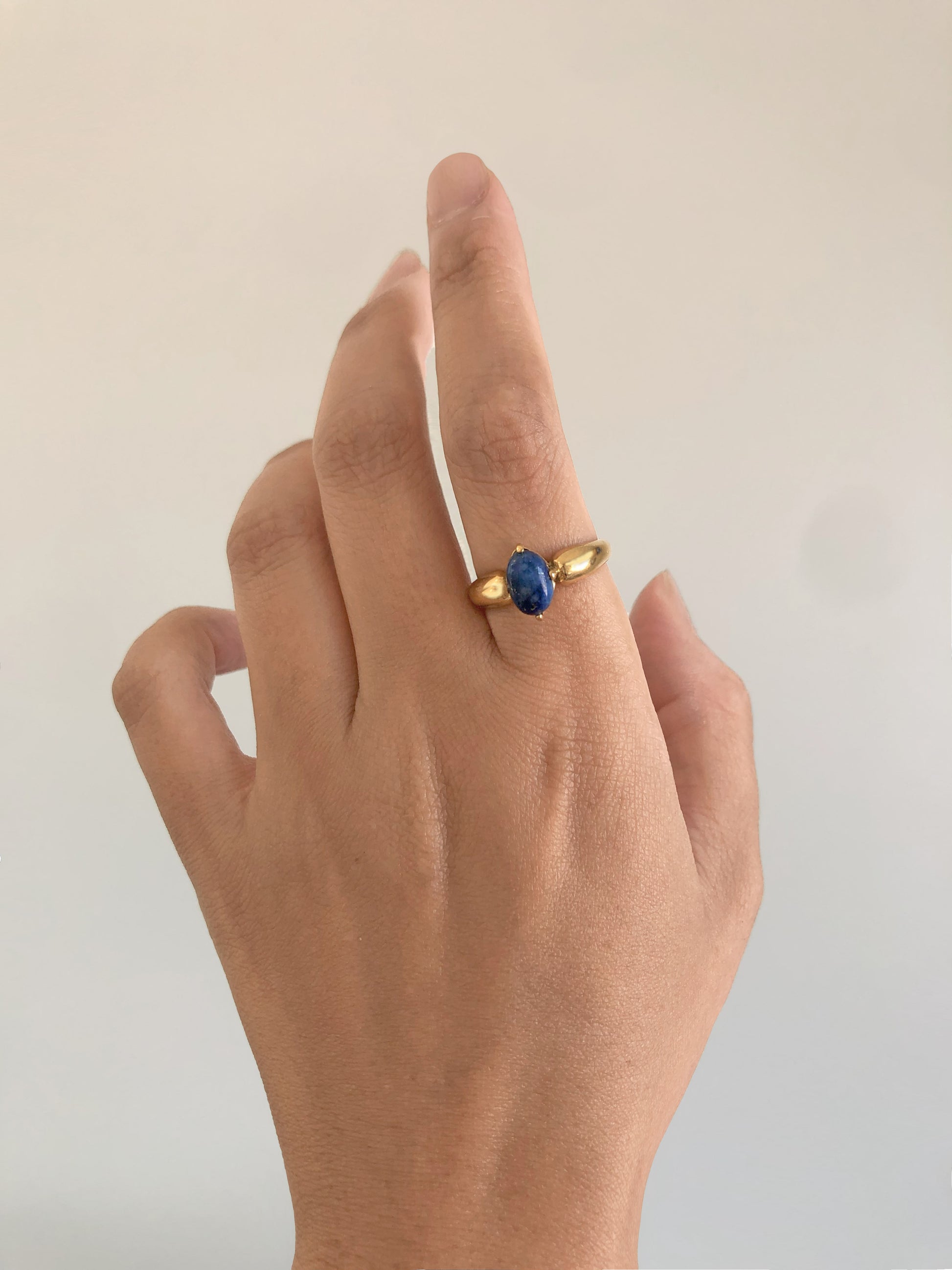 FAVES Katella Rings pair – oval white CZ and lapis solitaires on polished gold bands