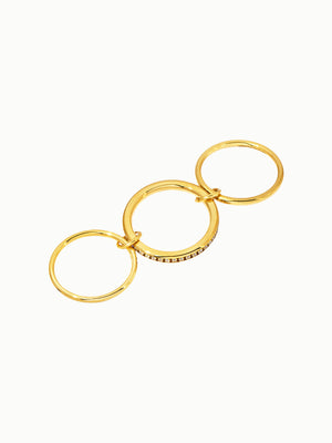 Three linked Capella rings in 18K gold with full eternity zirconia band design